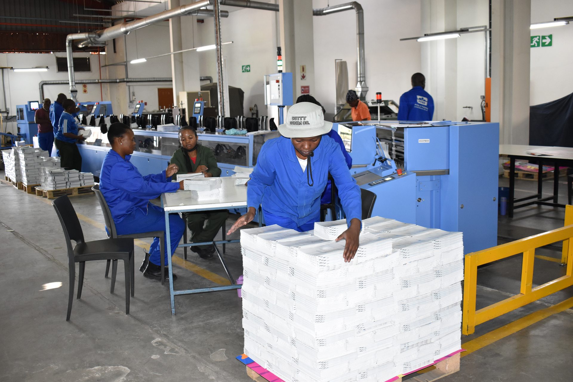 Staff stacking finished print runs onto pallets